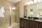 The en-suite bathroom features a glass door walk-in shower with dual vanity